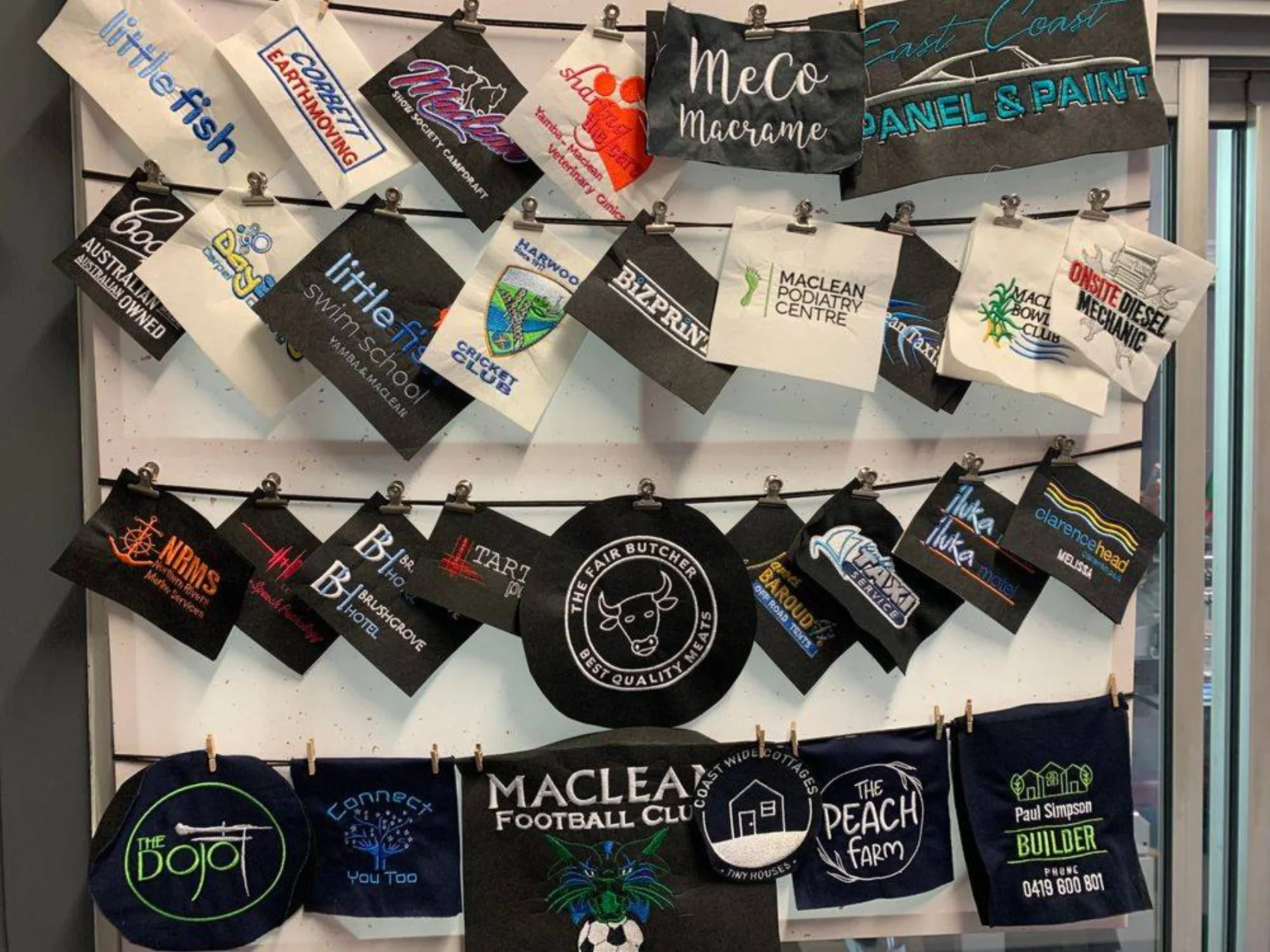 Sample wall of embroidered logos for local Clarence Valley businesses and clubs